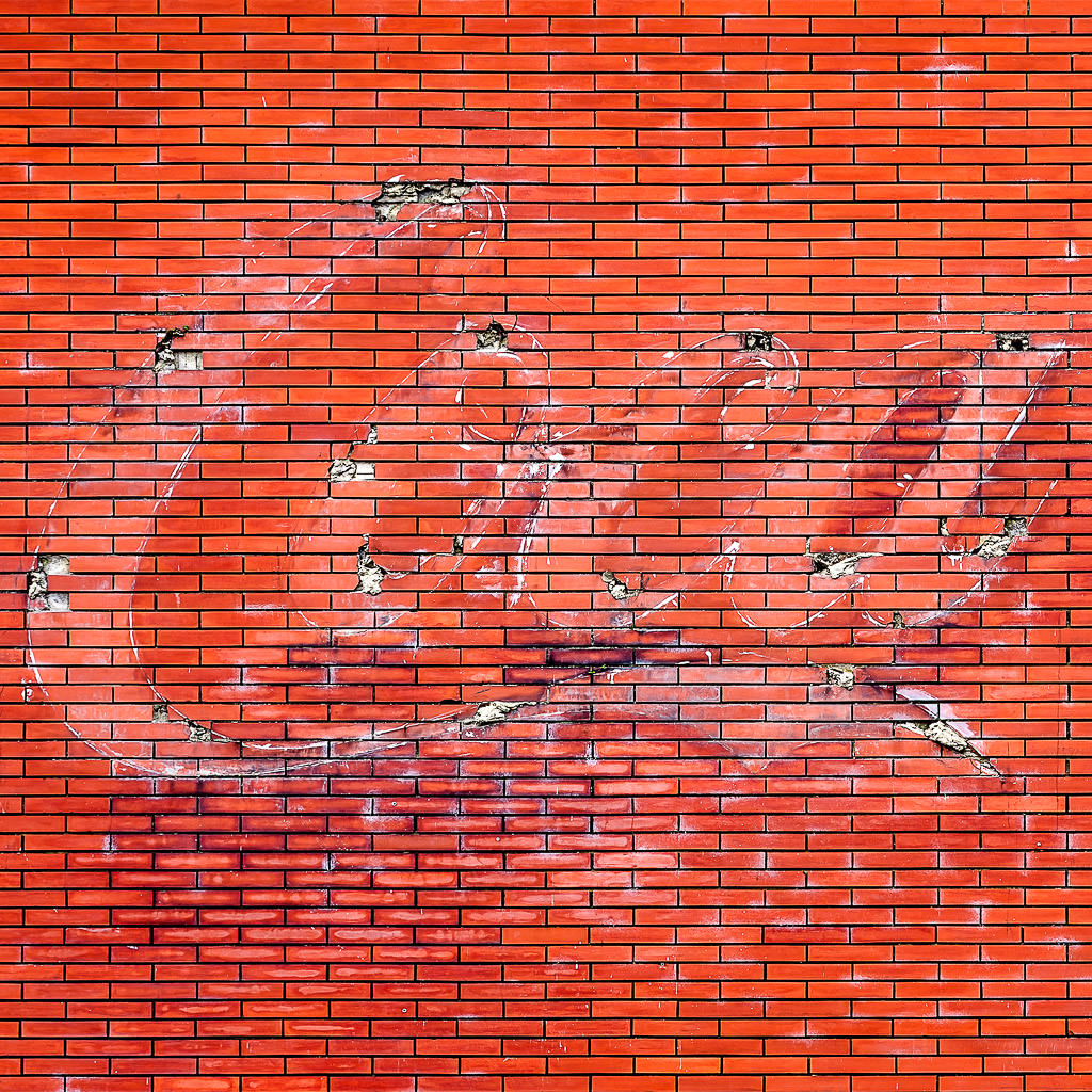 Logo de Coca Cola en  pared de ladrillos